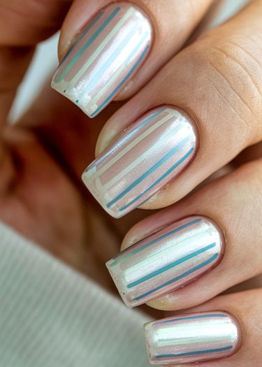 Elegant geometric nail art featuring pastel stripes on pearlescent white nails.