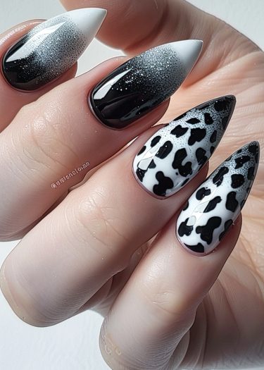 Elegant black and white ombre nails with cow print design for stunning nail art inspiration.