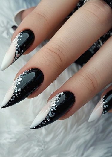 Elegant black and white gradient stiletto nails with rhinestones for a sophisticated manicure.