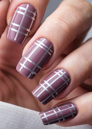 Elegant muted mauve plaid nails with metallic silver design for a sophisticated manicure.