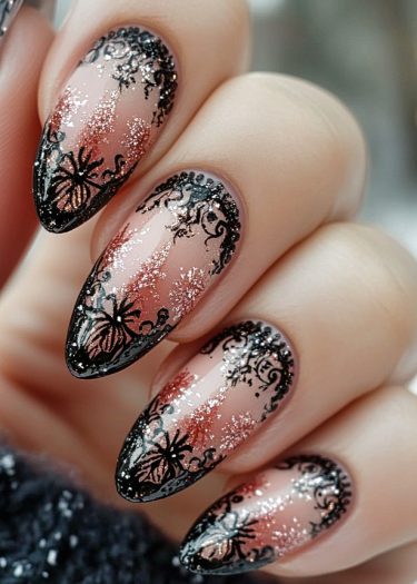 Elegant stiletto nails with intricate black lace design and glitter on a pink base.