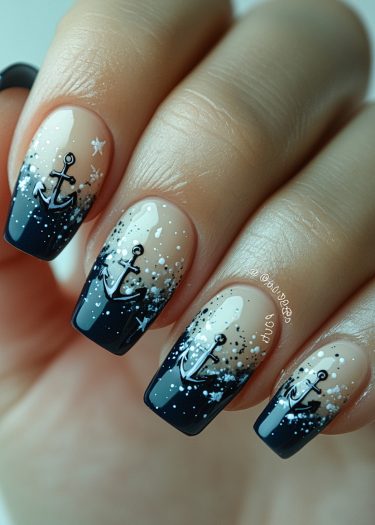 Elegant gradient navy nail art with anchors and ocean-inspired sparkles.