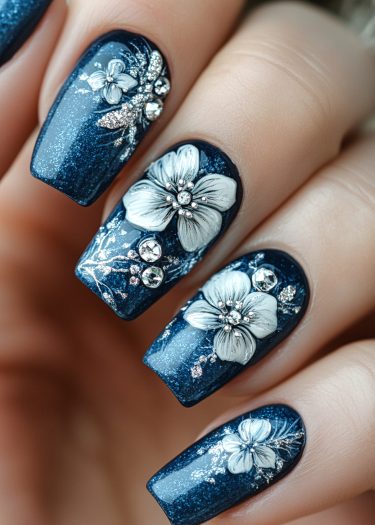 Elegant deep blue floral nail art with 3D designs and sparkling accents for glamorous looks.