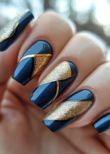 Elegant navy blue and gold geometric nail art showcasing sophisticated design and luxurious finish.