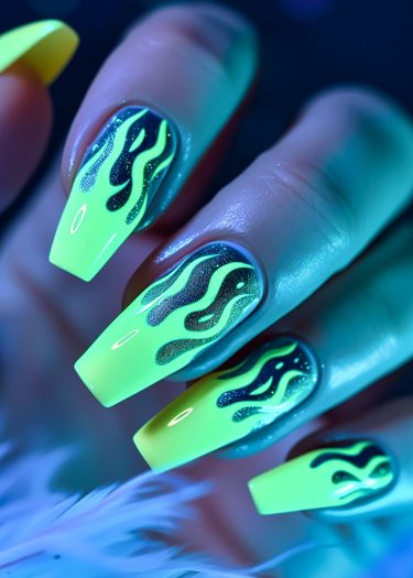 Vibrant neon flame nail art in glossy coffin shape with fluorescent yellow and black designs.