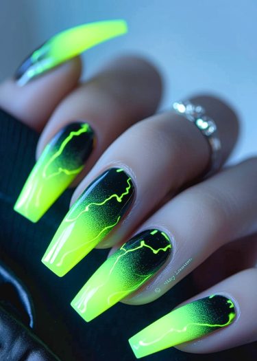 Trendy coffin-shaped nails with neon gradient and wavy designs for bold, stylish nail art.