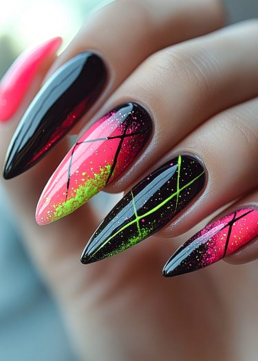 Bold neon pink and black stiletto nails with glitter and crisscross patterns.