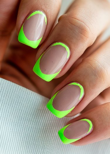 Trendy nude and neon green nail art design on square-shaped nails.