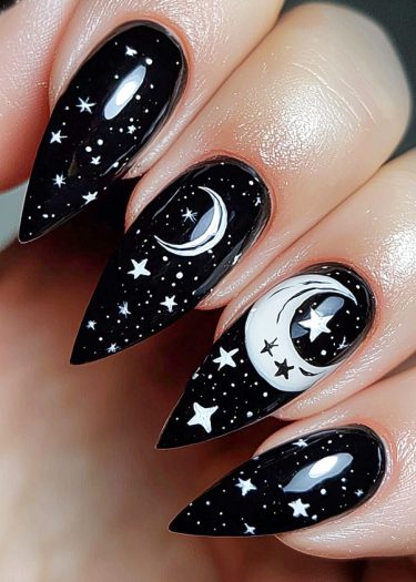 Stunning starry night nail art with black polish, white stars, and crescent moons design.