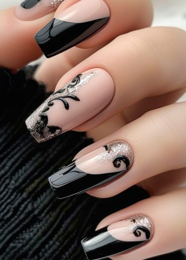 Elegant nude nails with black tips and silver glitter accents for chic nail art design.