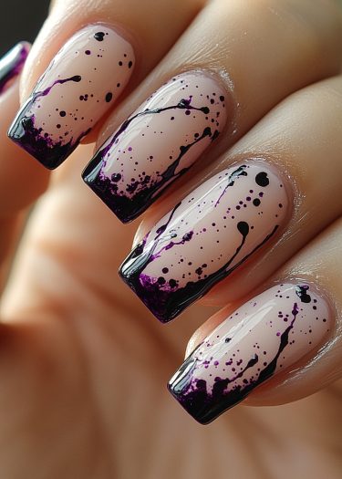 Intricate nude pink gradient nail art with black and purple splatter design for a modern look.