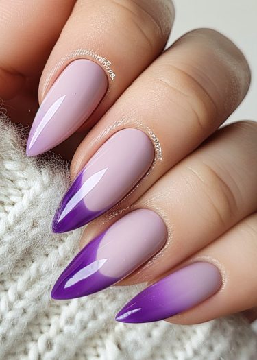 Elegant almond-shaped ombre nails in lavender and purple on a cozy background.