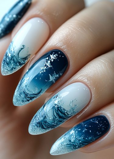 Stunning ocean wave nail art design featuring blue ombre and sparkling sea foam accents.