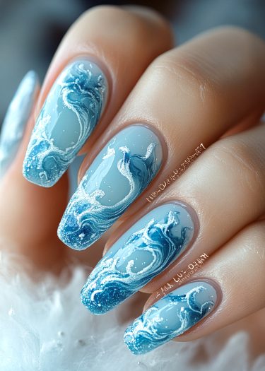 Ocean wave nail art in stunning blue and white design with glossy finish.