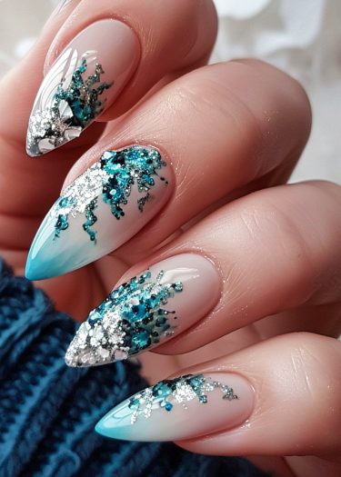 Elegant oceanic nail art featuring gradient blue tips and sparkling rhinestones.