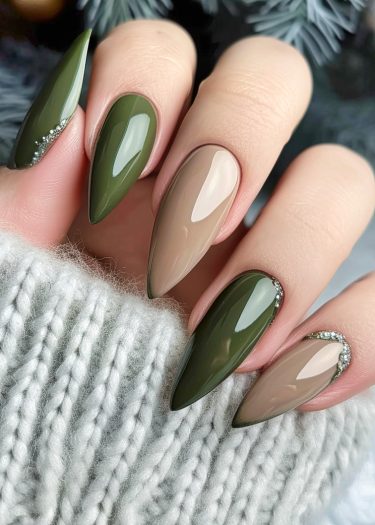 Elegant olive green and beige nail art with silver embellishments against a cozy winter backdrop.