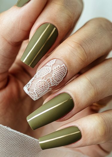 Elegant olive green nails with gold stripes and intricate lace design on the ring finger.