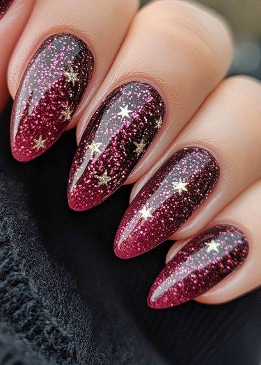 Elegant ombre burgundy nail art with glitter and golden stars for a glamorous look.