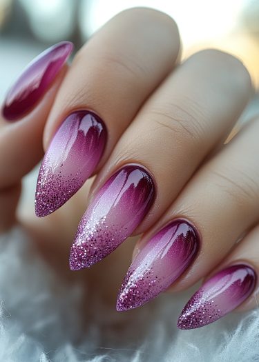 Elegant stiletto nails with ombre plum-lavender gradient and sparkling glitter tips.