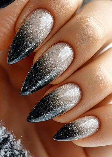 Elegant almond-shaped ombre glitter nails in black, showcasing stunning gradient and shine.