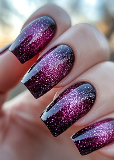 Stunning ombre glitter nails in vibrant pink and deep base, perfect for chic styles.