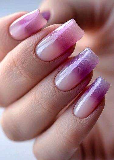 Stunning ombre pink nail design with glossy finish and expertly manicured square-shaped nails.