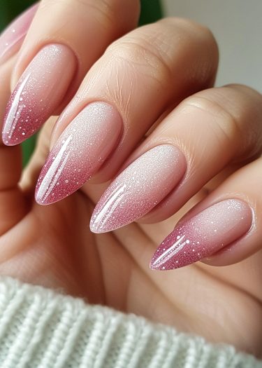 Elegant ombre pink nails with glitter showcasing a sophisticated manicure design.