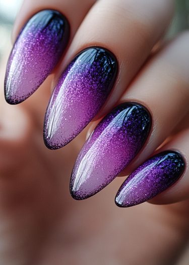 Elegant almond-shaped nails with a shimmering purple gradient design for a glamorous look.