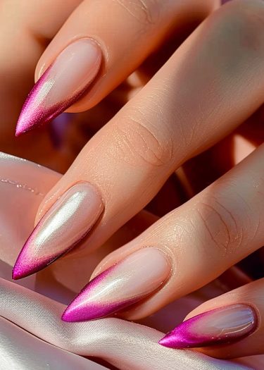 Stunning stiletto nails featuring a vibrant pink-to-magenta gradient and elegant nail art design.