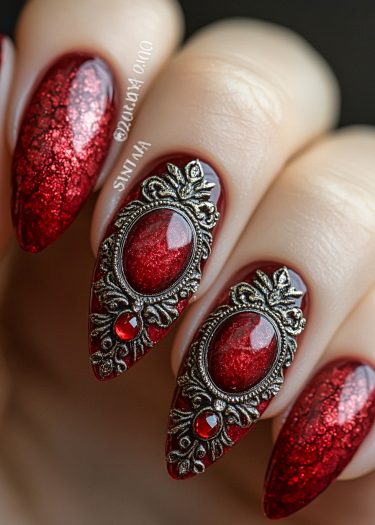 Luxurious red stiletto nail art with intricate metallic embellishments and sparkling gems.