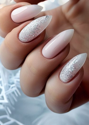 Elegant stiletto nails with pink base and glitter design showcase sophisticated nail artistry.