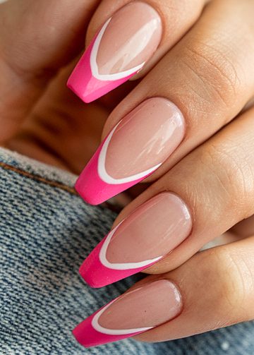 Elegant pink-tipped nails with white accents against a textured denim background.