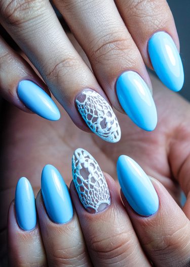 Chic pastel blue nails with elegant lace design, showcasing stunning nail art creativity.