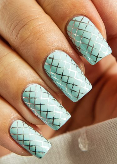 Elegant pastel blue lattice nail art showcases a modern, polished manicure with geometric design.