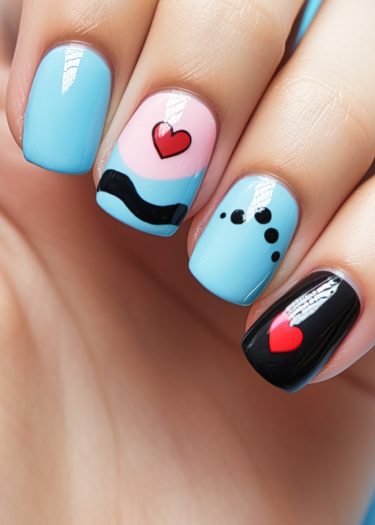 Colorful pastel blue nail art with intricate designs and bold accents for a trendy manicure.