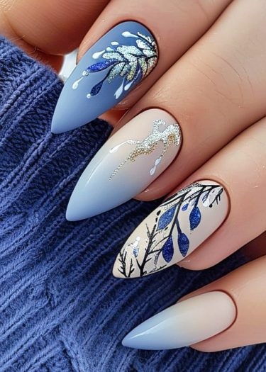 Elegant pastel blue stiletto nail art with intricate designs and metallic accents.