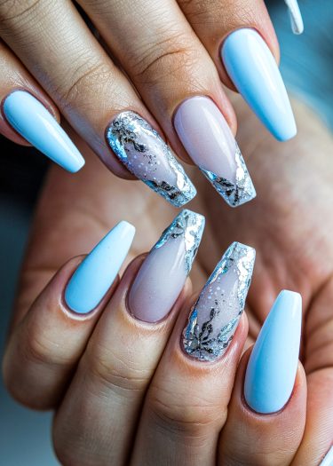 Elegant pastel blue and pink nail art with intricate silver accents on coffin-shaped nails.