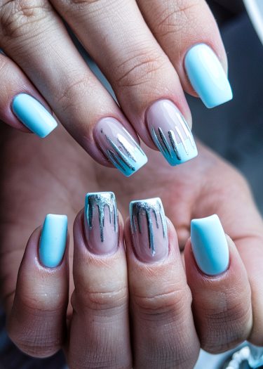 Elegant pastel blue and metallic nail art showcasing modern design and creativity.