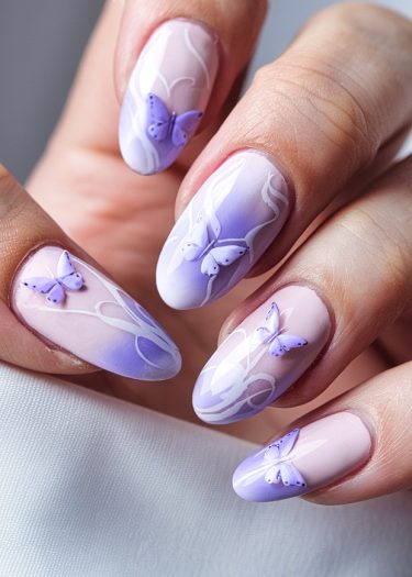 Pastel butterfly nail art featuring ombre pink and lavender shades with intricate designs.