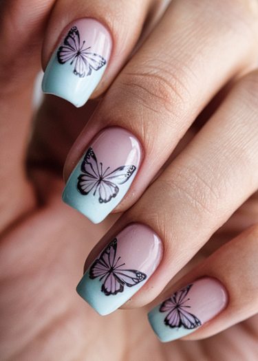 Pastel butterfly nail art with elegant designs and a soothing ombré gradient.