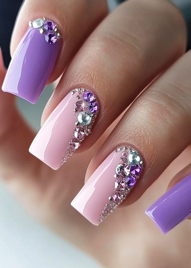 Elegant pastel coffin nails with lavender and pink hues, adorned with sparkling jewel accents.