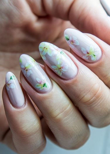 Elegant pastel floral nail art in lavender and pink with intricate hand-painted designs.