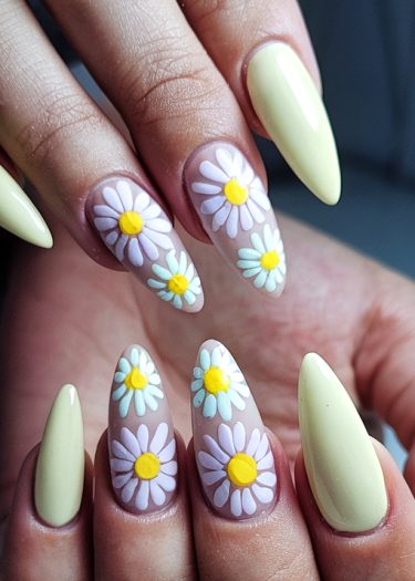 Elegant pastel floral nail art with daisy designs on almond-shaped nails.