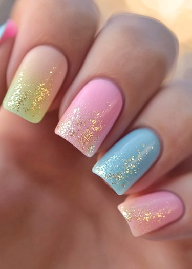 Pastel gradient nail art with gold glitter, showcasing elegant and trendy spring-inspired designs.