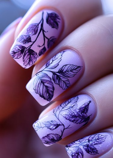 Elegant pastel lavender nail art featuring intricate leaf designs and subtle shimmer.