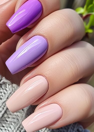 Elegant pastel lilac manicure on beautifully manicured nails against cozy gray fabric.