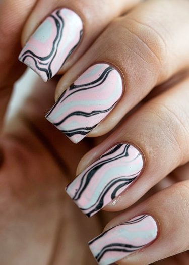 Pastel marble nail art design with elegant black accents on perfectly manicured square nails.