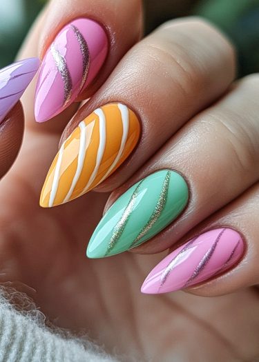 Vibrant pastel nail art featuring almond-shaped nails with intricate glitter designs and vivid colors.