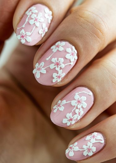 Pastel pink cherry blossom nails with intricate floral designs for elegant nail art lovers.