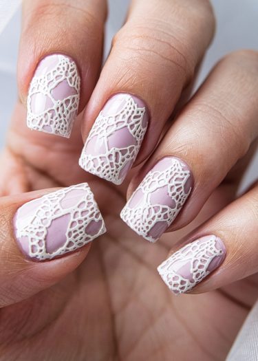 Elegant pastel lilac nails with intricate white lace design for stylish nail art inspiration.